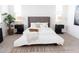 Bright bedroom with a plush bed, decorative pillows, stylish lamps, and chic decor at 5916 S Daisy Patch Pl, Phoenix, AZ 85040