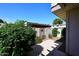 Backyard featuring lush greenery, a decorative gate, and a patio area at 5942 N 83Rd St, Scottsdale, AZ 85250