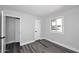 Sun-filled bedroom with gray wood-look floors and a window with natural light at 5942 N 83Rd St, Scottsdale, AZ 85250