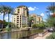 Luxury condo building exterior showcasing a waterfront view, manicured landscaping and palm trees at 5942 N 83Rd St, Scottsdale, AZ 85250