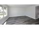 Spacious living area with sleek wood-look flooring and ample natural light from large window at 5942 N 83Rd St, Scottsdale, AZ 85250