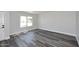 Bright living area with modern wood-look flooring, fresh paint, and a large window at 5942 N 83Rd St, Scottsdale, AZ 85250