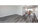 Inviting living space featuring modern gray wood-look floors and an open layout to the dining area at 5942 N 83Rd St, Scottsdale, AZ 85250