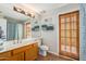 Bathroom features a natural wood sliding door, decorative towels, and a sink with vanity at 6122 E Saddleback St, Mesa, AZ 85215