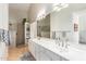 Bathroom featuring double sinks, lots of light and a shower with glass block at 6122 E Saddleback St, Mesa, AZ 85215