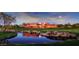 Stunning clubhouse surrounded by lush landscape and a beautiful pond on the well-manicured golf course at 6122 E Saddleback St, Mesa, AZ 85215