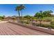 Spacious outdoor deck offers stunning views of the lush golf course and palm trees at 6122 E Saddleback St, Mesa, AZ 85215
