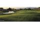 Expansive golf course view with a water feature and scenic rolling hills; ideal for golf enthusiasts at 6122 E Saddleback St, Mesa, AZ 85215