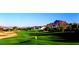 Scenic view of the meticulously maintained golf course with mountain views and blue sky at 6122 E Saddleback St, Mesa, AZ 85215