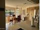 Kitchen and eating area with stainless steel refrigerator, light wood cabinetry and tile floors at 6122 E Saddleback St, Mesa, AZ 85215