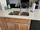 Stainless steel double sink inset in an island featuring granite countertops and wood cabinets at 6122 E Saddleback St, Mesa, AZ 85215