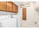 Bright laundry room with upper and lower cabinets and utility sink at 6122 E Saddleback St, Mesa, AZ 85215