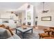 Spacious living room with vaulted ceiling, tile floors, a fireplace, and comfortable seating at 6122 E Saddleback St, Mesa, AZ 85215