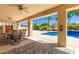 Covered patio features an outdoor dining area and view of the pool at 6122 E Saddleback St, Mesa, AZ 85215