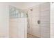 Shower features natural stone-look tiling, glass blocks and pebble style flooring at 6122 E Saddleback St, Mesa, AZ 85215