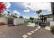 Landscaped backyard oasis includes a pool, patio area, shed, and a privacy fence at 6539 E Sharon Dr, Scottsdale, AZ 85254