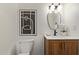 Bathroom featuring wood cabinets, white counters, updated vanity, and framed modern art at 6539 E Sharon Dr, Scottsdale, AZ 85254
