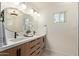 Bathroom featuring double vanity, modern lighting, decorative mirror and white quartz counters at 6539 E Sharon Dr, Scottsdale, AZ 85254