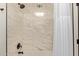Updated bathroom showcasing a modern tiled shower, shower head and white shower curtain at 6539 E Sharon Dr, Scottsdale, AZ 85254