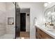 Elegant bathroom features a double sink vanity, modern lighting, and a tiled shower at 6539 E Sharon Dr, Scottsdale, AZ 85254