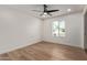 Well-lit bedroom has attractive wood-look floors, a ceiling fan, and a large window at 6539 E Sharon Dr, Scottsdale, AZ 85254