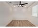 Bedroom featuring wood-look tile flooring, ceiling fan, and large window for ample natural light at 6539 E Sharon Dr, Scottsdale, AZ 85254