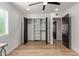Bedroom includes open closet with modern sliding doors, shelving, and hanging rods at 6539 E Sharon Dr, Scottsdale, AZ 85254