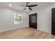 The bedroom offers wood-look flooring, a ceiling fan, and a closet with black doors at 6539 E Sharon Dr, Scottsdale, AZ 85254