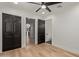 Bedroom features wood-look tile flooring and multiple closets for ample storage at 6539 E Sharon Dr, Scottsdale, AZ 85254