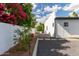 Side yard featuring low-maintenance gravel, concrete pavers, xeriscape landscaping, and a gated entrance at 6539 E Sharon Dr, Scottsdale, AZ 85254