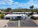 Aerial view of the home showcasing modern landscaping, black trim, and a long driveway with plenty of parking at 6539 E Sharon Dr, Scottsdale, AZ 85254
