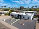 View of the home featuring updated desert landscaping, black trim, and long driveway with parking at 6539 E Sharon Dr, Scottsdale, AZ 85254