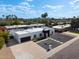 Aerial view of a modern home with black trim, desert landscaping, and a large driveway with plenty of parking at 6539 E Sharon Dr, Scottsdale, AZ 85254