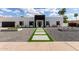 Daytime front exterior view featuring a sleek, modern design with concrete pathway and landscaped yard at 6539 E Sharon Dr, Scottsdale, AZ 85254