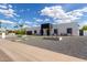 Modern home featuring a sleek design, gravel landscaping, and a unique concrete pathway to the entrance at 6539 E Sharon Dr, Scottsdale, AZ 85254