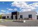 Modern home's front exterior with gravel landscaping and unique concrete pathway leading to the entrance at 6539 E Sharon Dr, Scottsdale, AZ 85254