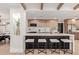 Gourmet kitchen with breakfast bar, quartz countertops, stainless steel appliances, and wood-look cabinets at 6539 E Sharon Dr, Scottsdale, AZ 85254