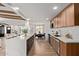 Open-concept kitchen featuring a large island, stainless appliances, wood cabinets, and modern finishes at 6539 E Sharon Dr, Scottsdale, AZ 85254