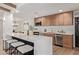 Spacious kitchen island with seating, modern finishes, stainless steel appliances, and wood flooring at 6539 E Sharon Dr, Scottsdale, AZ 85254