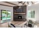 Stylish living room featuring wood-look tile flooring, a modern fireplace, and a view of the backyard pool at 6539 E Sharon Dr, Scottsdale, AZ 85254