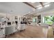 Spacious open-concept living area with wood beams, tile flooring, and a seamless flow to the modern kitchen at 6539 E Sharon Dr, Scottsdale, AZ 85254
