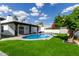 Beautiful backyard pool with new turf and black trim on the modern home's covered patio and sitting area at 6539 E Sharon Dr, Scottsdale, AZ 85254