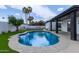 Sparkling pool, manicured landscaping, and covered patio create a serene backyard oasis for relaxation and enjoyment at 6539 E Sharon Dr, Scottsdale, AZ 85254