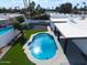 A sparkling pool is the focal point of this private backyard oasis with a manicured lawn at 6539 E Sharon Dr, Scottsdale, AZ 85254