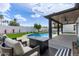 Inviting backyard pool surrounded by lush greenery, an outdoor seating area and a covered patio for relaxed living at 6539 E Sharon Dr, Scottsdale, AZ 85254