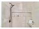 Modern shower features gray tile, built-in shelving, rainfall shower-head and hand-held sprayer at 6539 E Sharon Dr, Scottsdale, AZ 85254