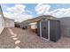 Backyard features a shed, chicken coop, desert landscaping and ample space for gardening at 681 W Belmont Red Trl, San Tan Valley, AZ 85143