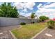 View of the property's expansive backyard with green grass, mature trees, and desert landscaping at 681 W Belmont Red Trl, San Tan Valley, AZ 85143