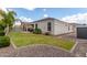 A spacious backyard featuring green grass, a patio, lush plants and desert landscaping at 681 W Belmont Red Trl, San Tan Valley, AZ 85143