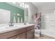 The guest bathroom includes double sinks, a bathtub and shower combination, and a decorative shower curtain at 681 W Belmont Red Trl, San Tan Valley, AZ 85143